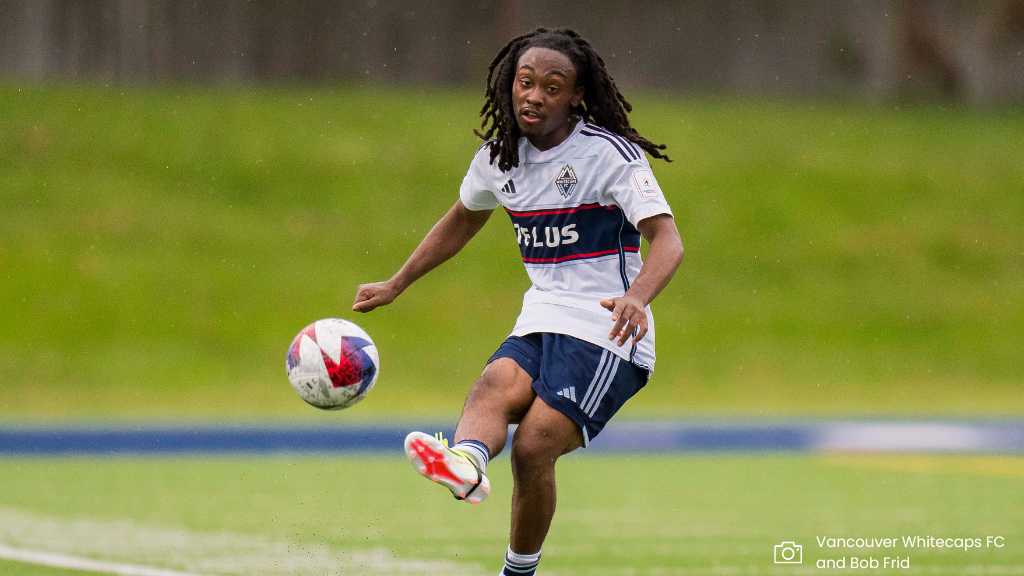 whitecaps player kicking ball