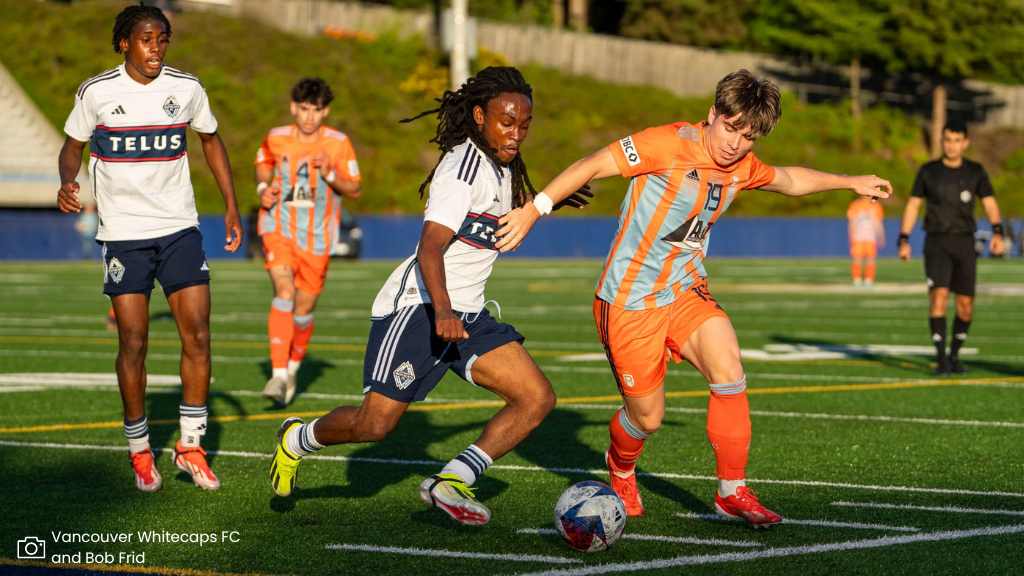 whitecaps player defending ball from rivers player