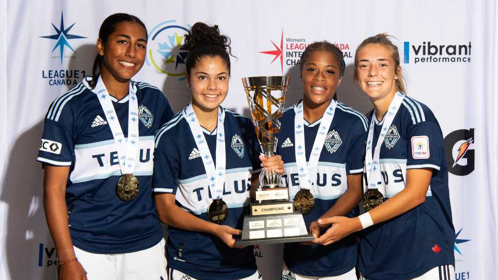 whitecaps players with trophy
