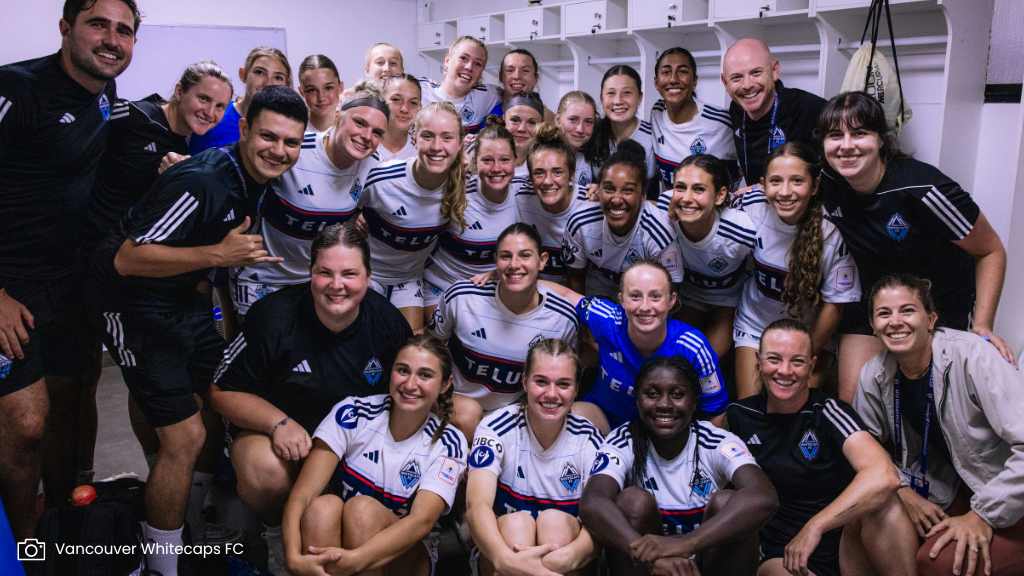 Whitecaps team celebrate in dressing room