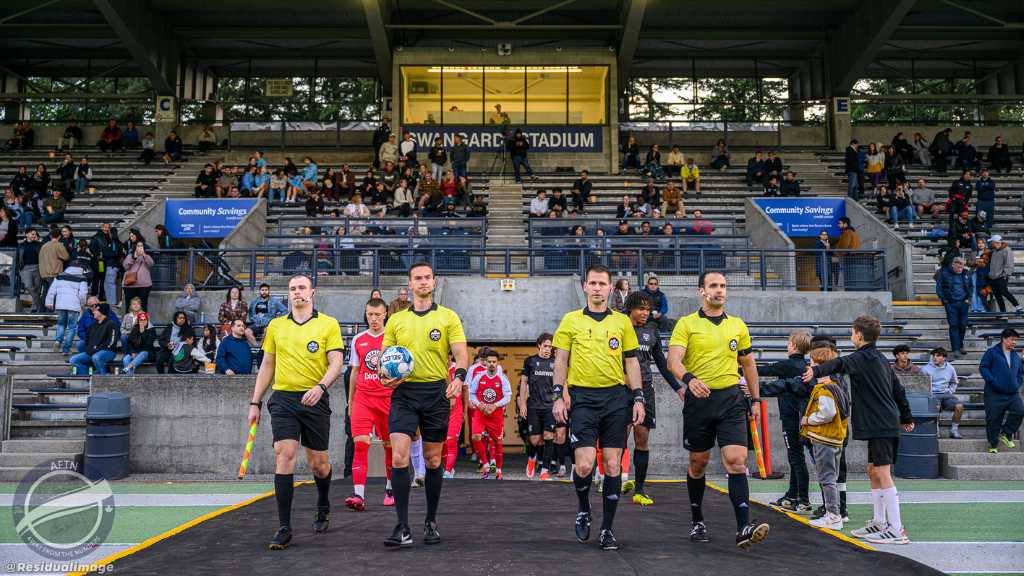 Officials and teams exit tunnel at Swangard Stadium